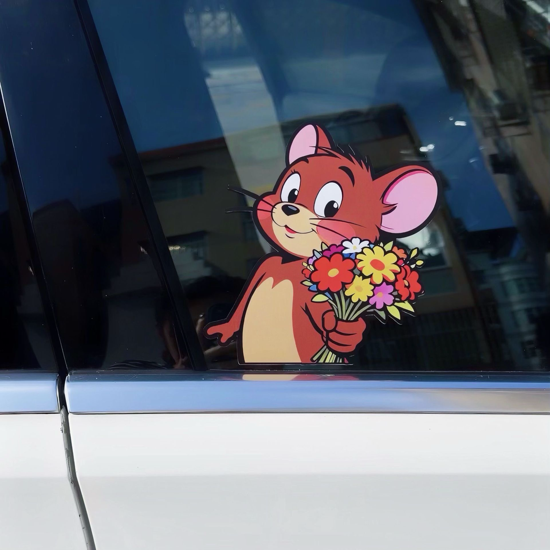 Detail shot of Jerry Mouse car window decal holding a colorful flower bouquet.