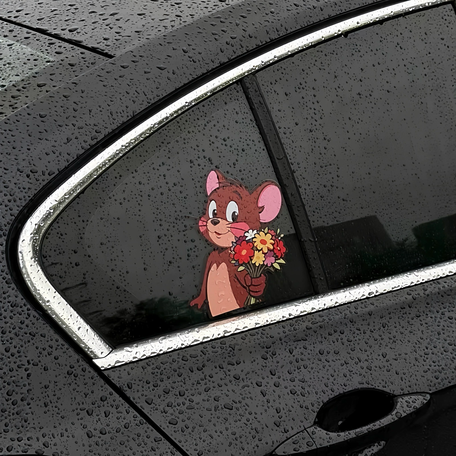 Jerry Mouse waterproof vinyl sticker showing durability on a wet car window during rain.