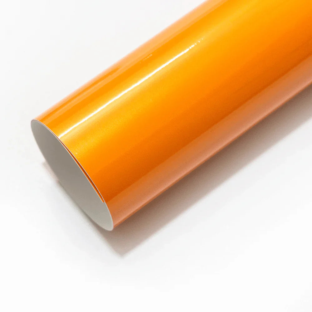 Roll of orange vinyl wrap on a white background