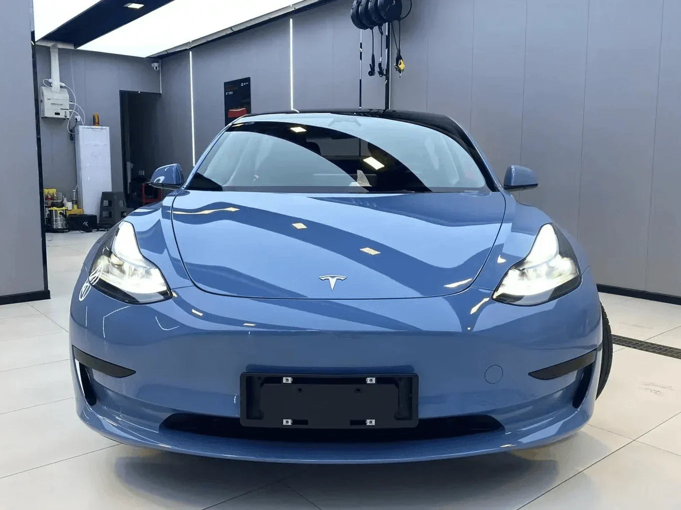 Blue Tesla car in a showroom setting