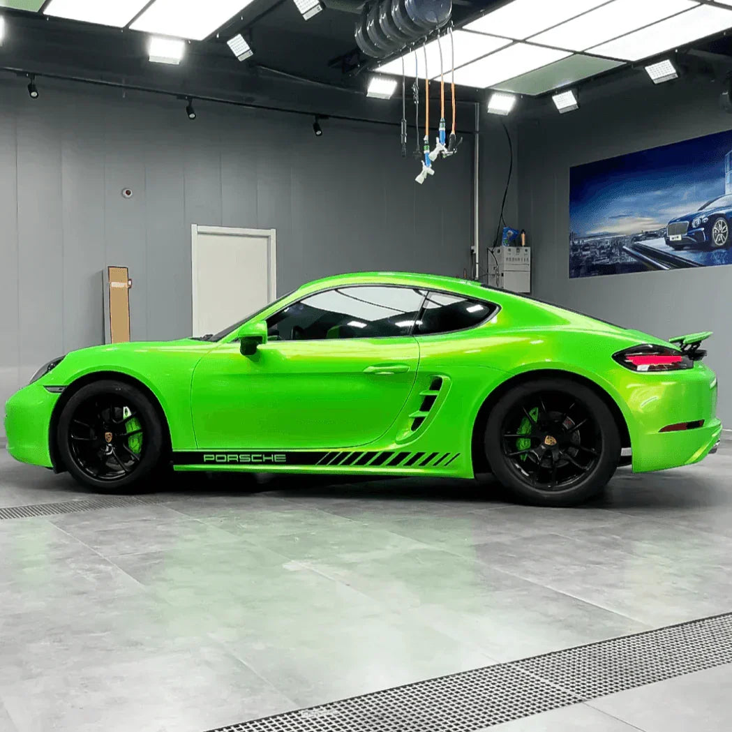 Green Porsche sports car in a showroom setting