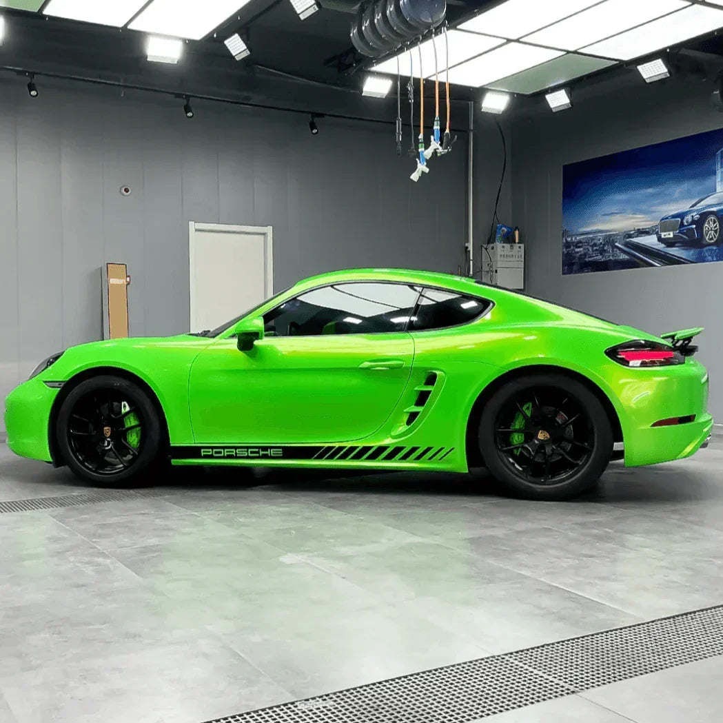 Green Porsche sports car in a showroom setting
